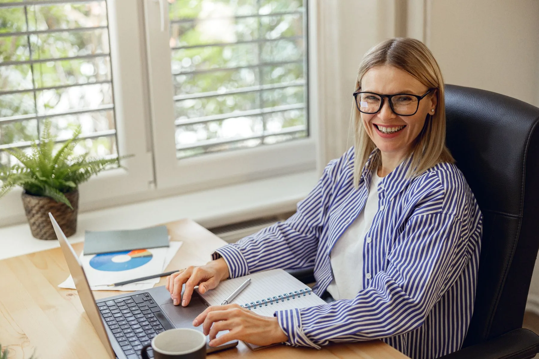 Happy woman working on laptop